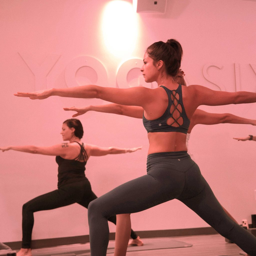 women in warrior yoga pose
